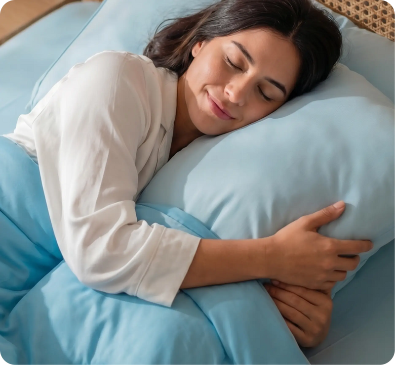 Woman sleeping peacefully hugging an Evercool® cooling pillow in Aqua Blue