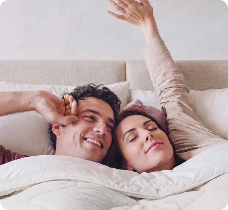 Couple lying close together in bed under Evercool® cooling bedding